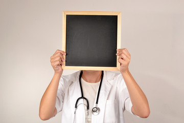 Doctor with blackboard in face