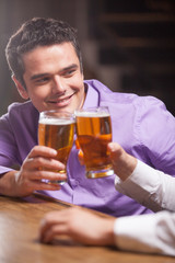closeup of young man talking at counter.