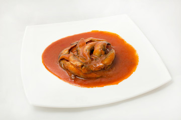 sprats in tomato sauce canned plate on a white background