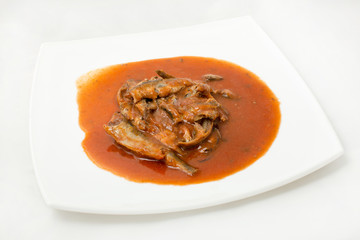sprats in tomato sauce canned plate on a white background