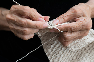 older woman crocheting