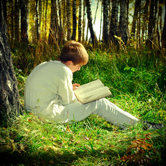 Fototapeta premium Boy with the Book outdoor