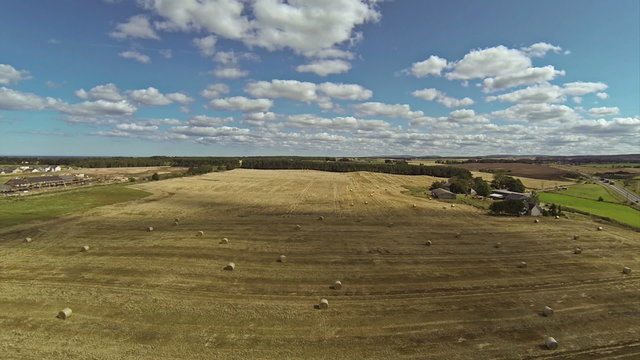 Two scenes of camera flying over bales of hay and very beautiful