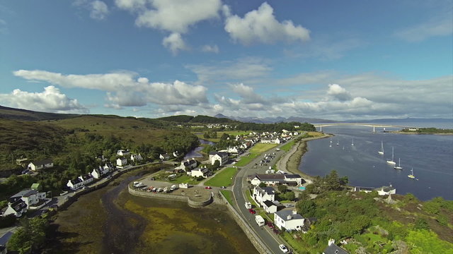 Camera flying over small port with sailing boats in town of Kyle