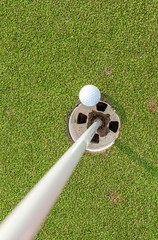 Aerial view of golf ball near pin and hole on green grass of gol © mrcmos