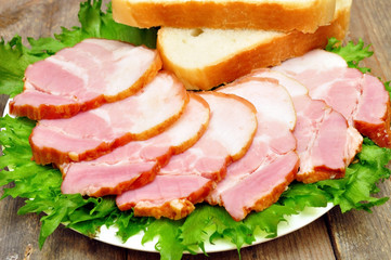 sliced bacon on a plate with bread