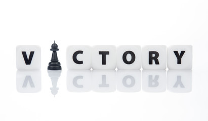 Letters block business concept for victory with chess charactor