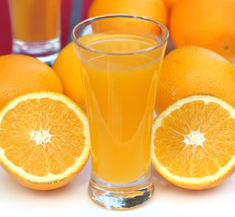 Oranges with glass of juice