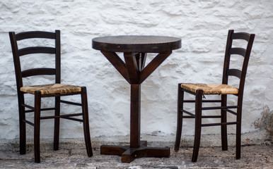 Rustic chairs and a table in Alberobello