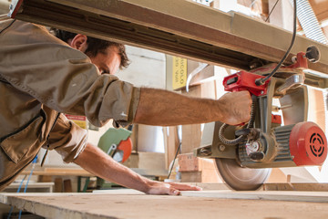 young carpenter work with circular saw