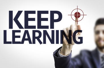Business man pointing the text: Keep Learning