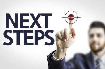 Business man pointing the text: Next Steps