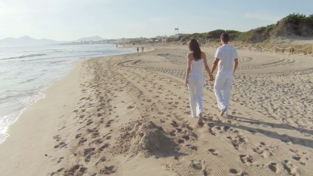 young couple having fun at the beach. majorca, spain.