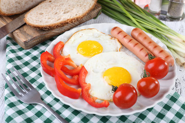 Scrambled eggs with sausage and vegetables served