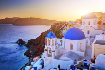 Oia town on Santorini island, Greece at sunset. Aegean sea.
