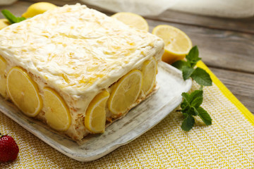Tasty lemon cake on table at home