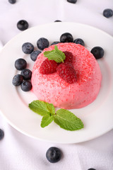 Round shaped cake with fruits and berries on plate on