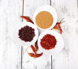 Spice with herbs and dried chilly pepper on wooden background