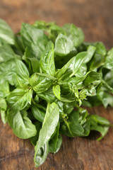 Green fresh basil on wooden background