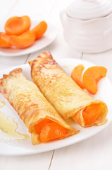 Pancakes with apricot slices