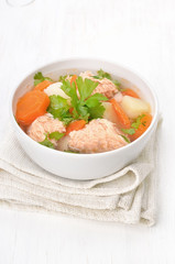 Fish soup with salmon in bowl
