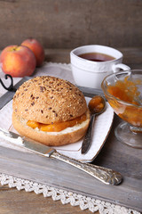 light breakfast with cup of tea and homemade jam on wooden