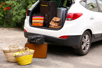 Suitcases and bags in trunk of car ready to depart for holidays
