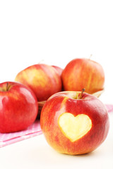 Red apple with heart isolated on white