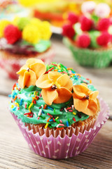 Delicious birthday cupcakes on table close-up