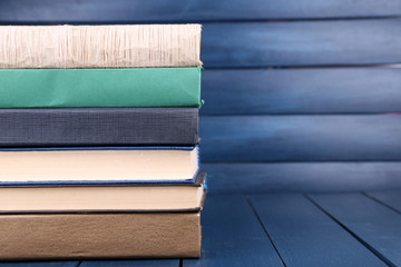 Books on dark blue wooden background