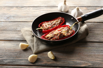 Delicious stuffed peppers in frying pan on table close-up