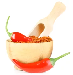 Poster Milled red chili pepper in wooden bowl isolated on white © Africa Studio