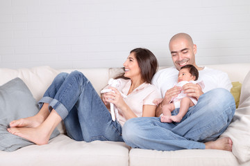 Young parents with little baby at home