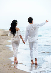Romantic couple walking along the seaside