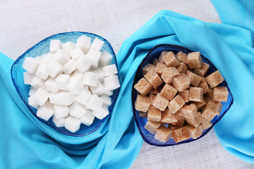 White and brown Refined sugar in color bowls