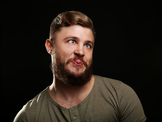 Obraz premium Portrait of handsome man with beard on black background