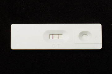 Pregnancy test on the dark background top view