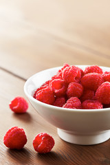 Fresh raspberries in white bowl