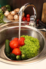Fresh vegetables in sink in kitchen