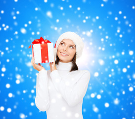 smiling woman in santa helper hat with gift box