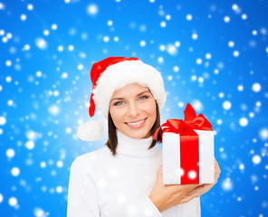 smiling woman in santa helper hat with gift box