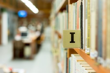 Library bookshelf closeup with letter