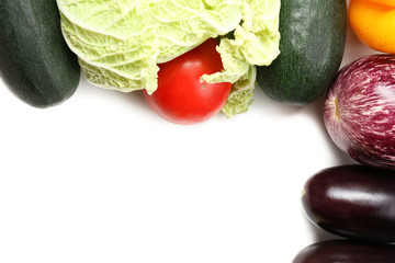 Frame of fresh organic vegetables on white background