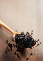 Fennel flower on wooden spoon