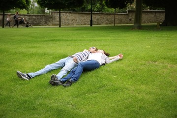 couple is lying on the grass