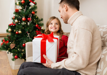 smiling father and daughter looking at each other