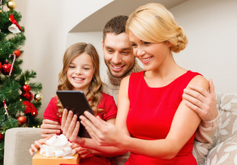 smiling family with tablet pc