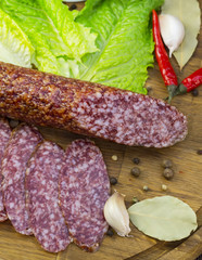 sausages on a wooden plate with vegetables in a restaurant