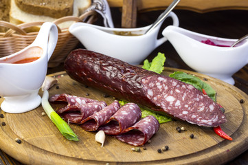 sausages on a wooden plate with vegetables in a restaurant