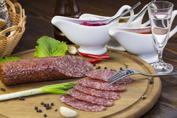sausages on a wooden plate with vegetables in a restaurant